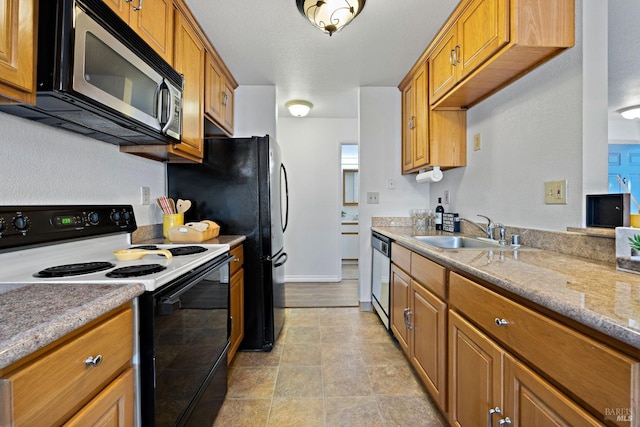 kitchen featuring appliances with stainless steel finishes, a textured ceiling, and sink