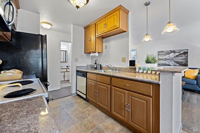 kitchen featuring kitchen peninsula, light stone counters, white appliances, sink, and hanging light fixtures