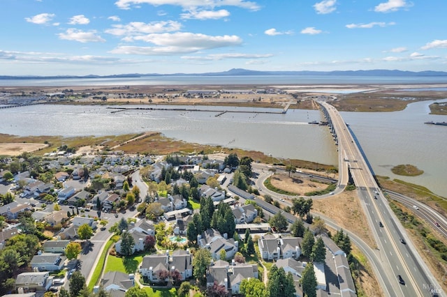 drone / aerial view with a water and mountain view