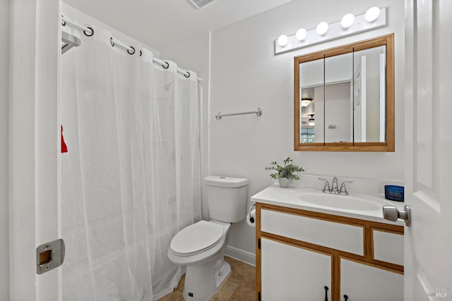 bathroom with a shower with shower curtain, tile patterned floors, vanity, and toilet