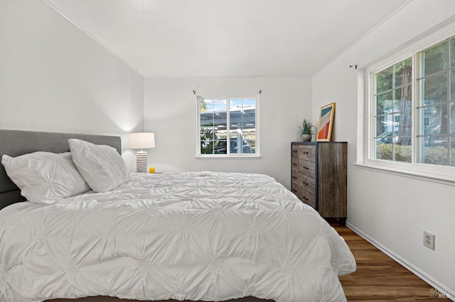 bedroom with hardwood / wood-style floors and ornamental molding