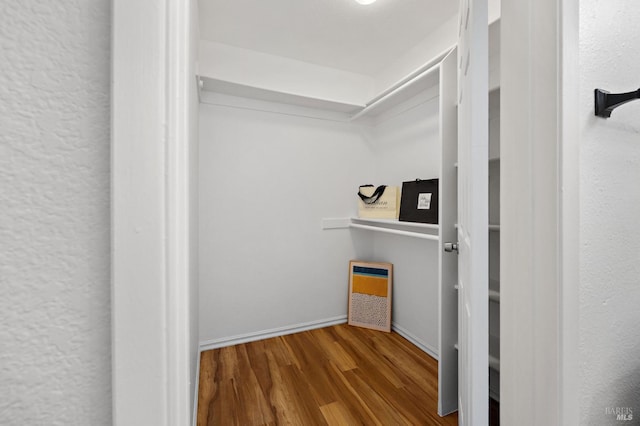 spacious closet featuring hardwood / wood-style floors