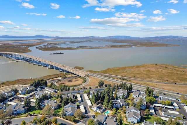 birds eye view of property featuring a water and mountain view