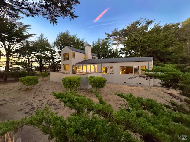 view of back house at dusk