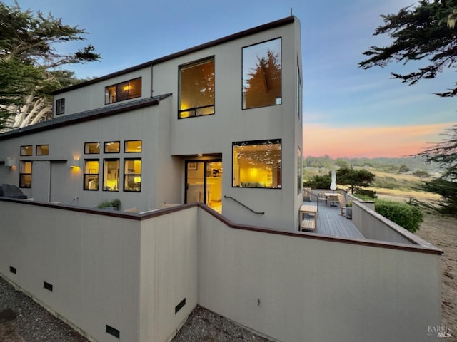 view of back house at dusk