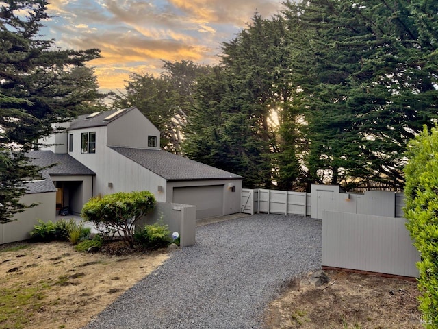 property exterior at dusk with a garage