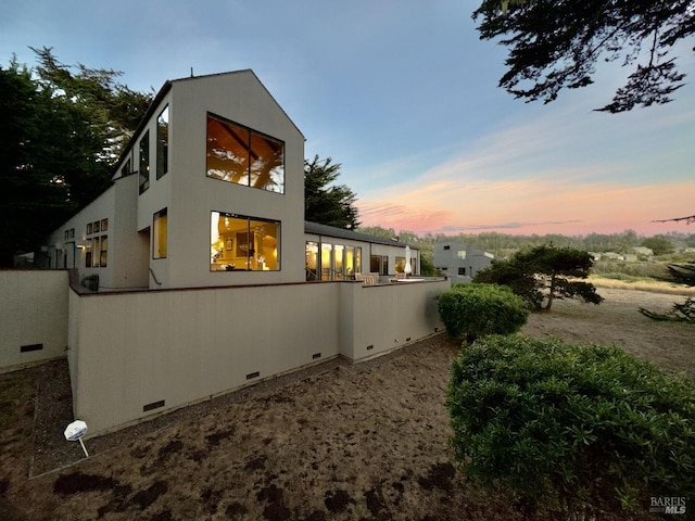 view of back house at dusk