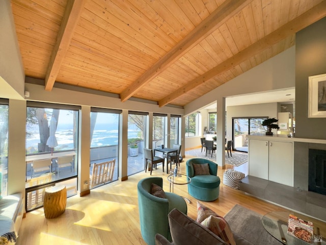 interior space featuring beamed ceiling, light hardwood / wood-style flooring, high vaulted ceiling, and wooden ceiling