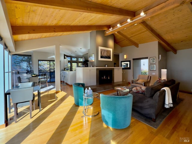 living room with wood ceiling, high vaulted ceiling, beam ceiling, and light wood-type flooring