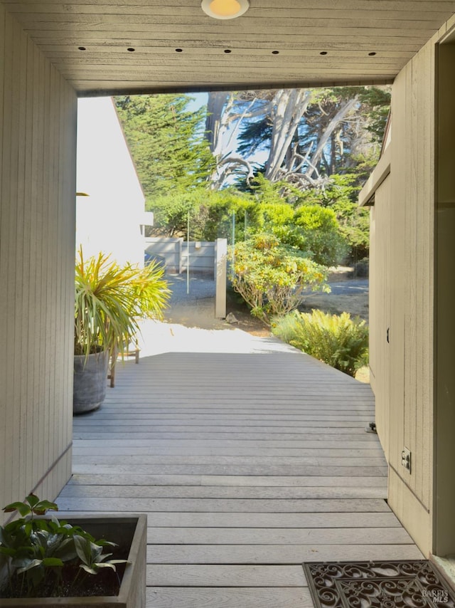 doorway to outside with wooden walls