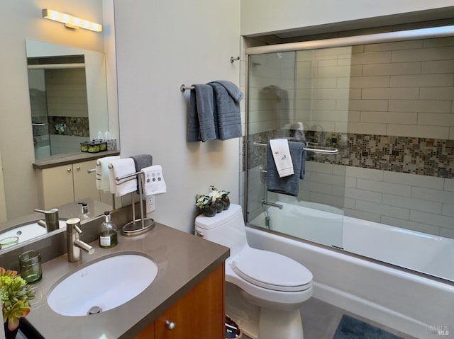 full bathroom with vanity, enclosed tub / shower combo, and toilet