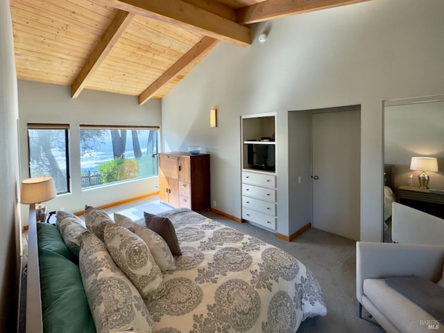 carpeted bedroom with beam ceiling and high vaulted ceiling