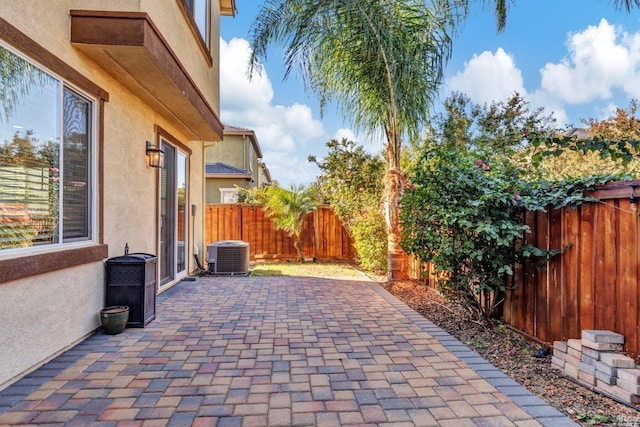 view of patio with central air condition unit and a fenced backyard
