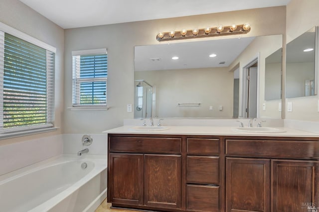 bathroom featuring vanity and shower with separate bathtub