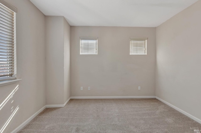 empty room featuring light carpet