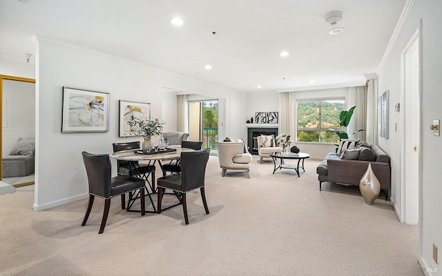 dining space featuring crown molding and light colored carpet