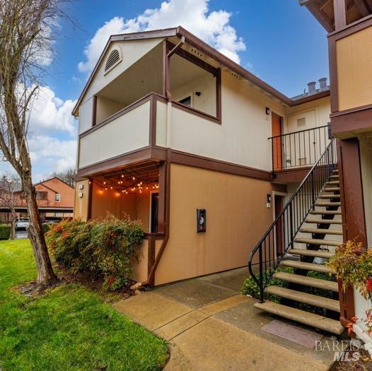 view of home's exterior with a balcony