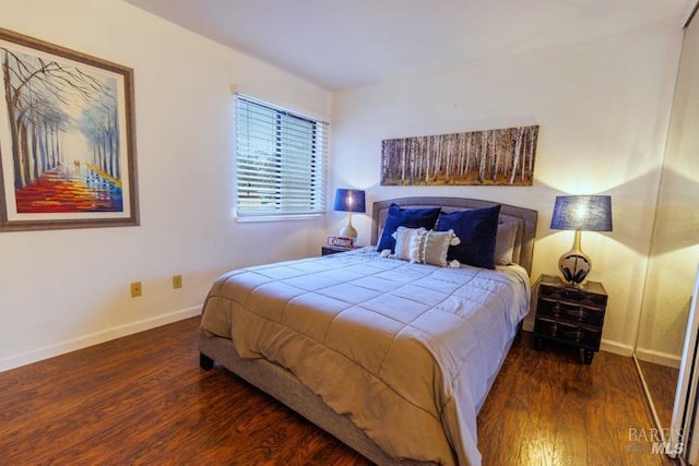 bedroom with dark hardwood / wood-style floors