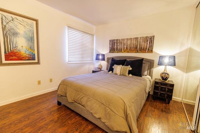 bedroom with dark wood-type flooring