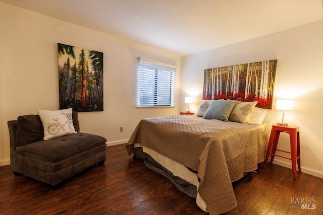 bedroom with dark hardwood / wood-style flooring