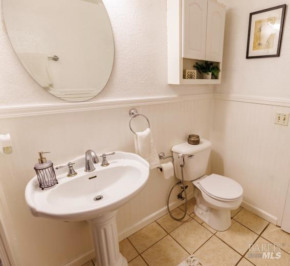 bathroom featuring tile patterned floors and toilet