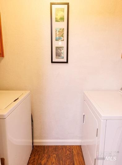 washroom with dark hardwood / wood-style flooring and washer and dryer