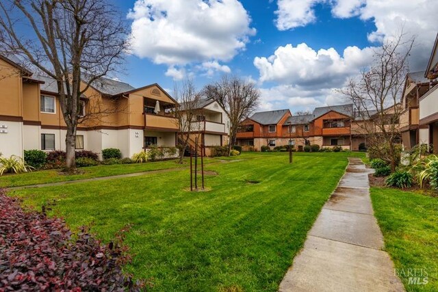 view of home's community with a lawn