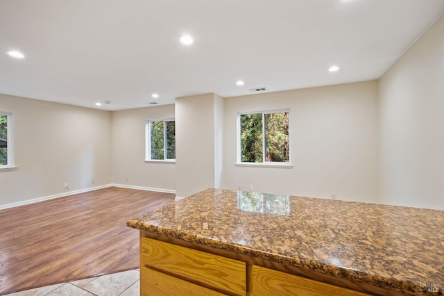 kitchen with stone counters and light wood-type flooring