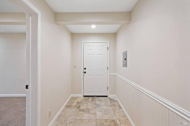 entryway with electric panel and light carpet