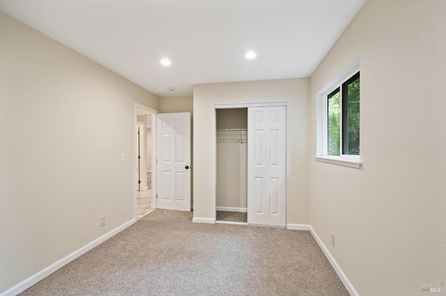 unfurnished bedroom featuring a closet and carpet floors