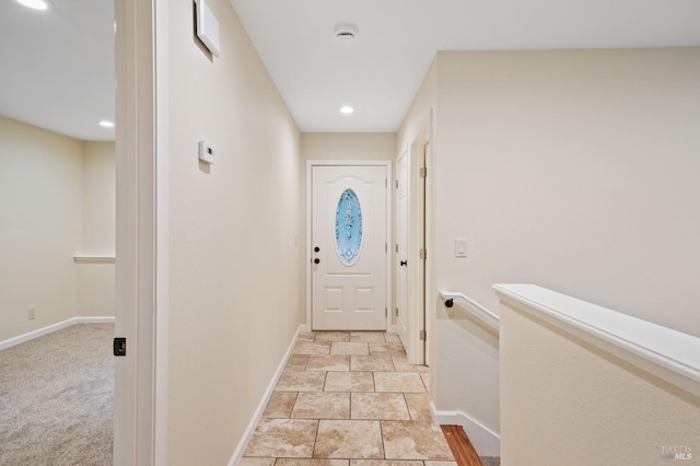 entryway with light colored carpet