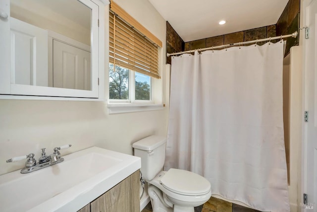 bathroom with vanity, toilet, and curtained shower