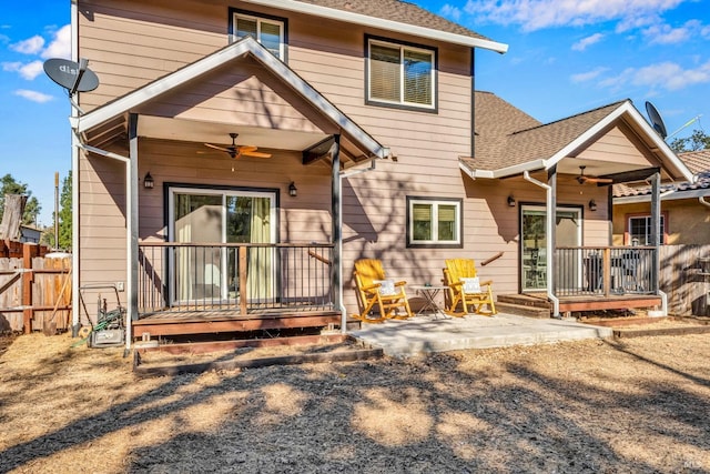 rear view of property featuring covered porch and ceiling fan