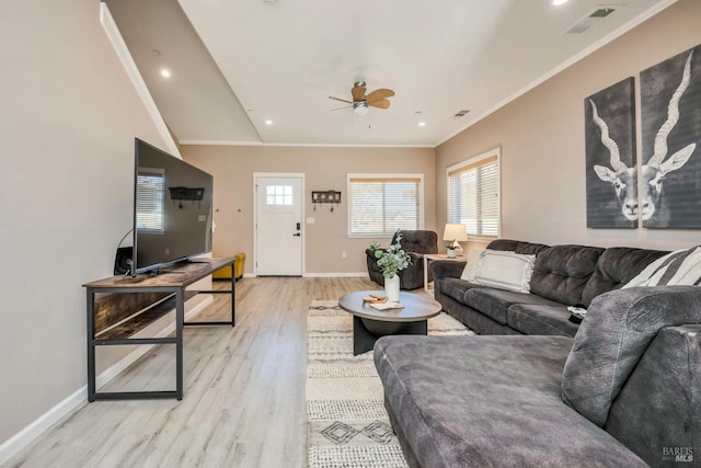 living room with ornamental molding, vaulted ceiling, light hardwood / wood-style floors, and ceiling fan