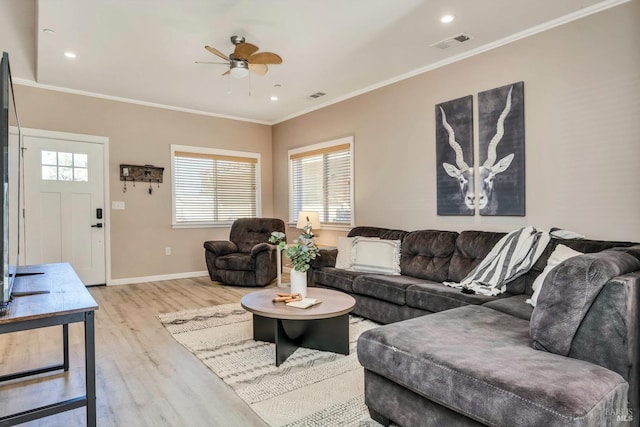 living room featuring light hardwood / wood-style floors, ornamental molding, and ceiling fan