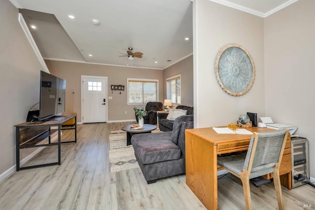 living room featuring crown molding, light wood-type flooring, and ceiling fan