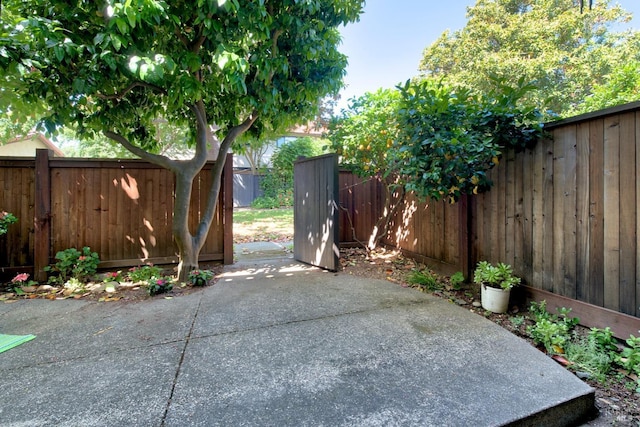 view of gate with a patio