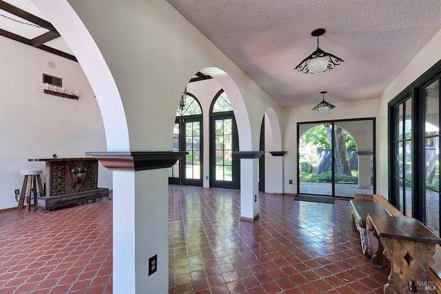 entrance foyer with vaulted ceiling and a textured ceiling