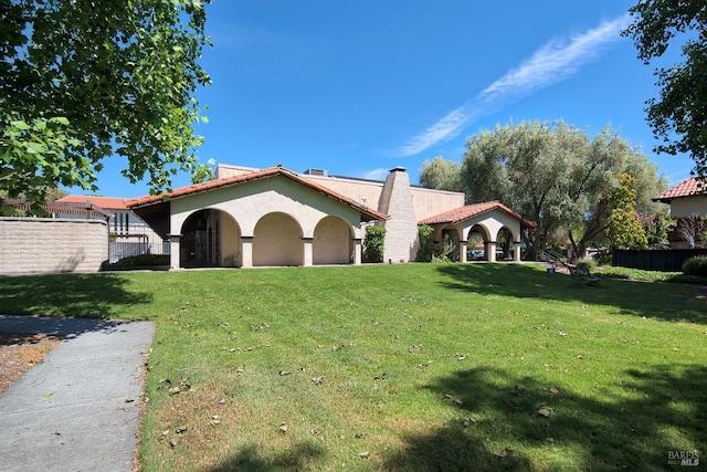 mediterranean / spanish house featuring a front lawn