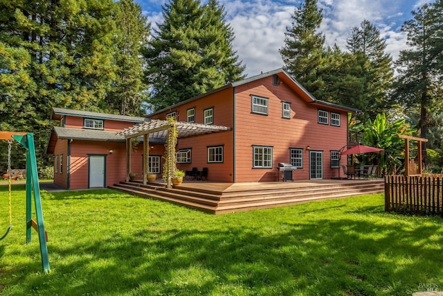 rear view of house with a deck and a lawn