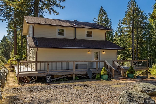 rear view of property featuring a wooden deck