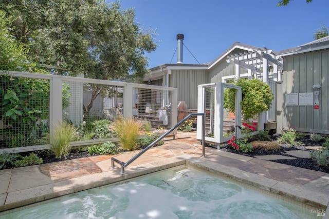 exterior space with an in ground hot tub