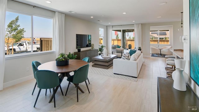 dining space with light hardwood / wood-style floors