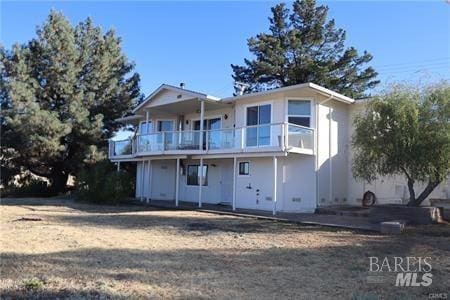 rear view of property featuring a balcony