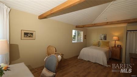 bedroom with beam ceiling and dark hardwood / wood-style floors