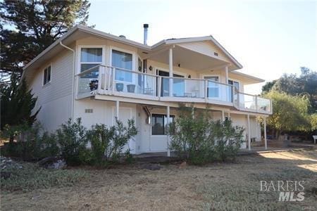 back of house with a balcony