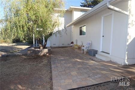 view of side of home with a patio area