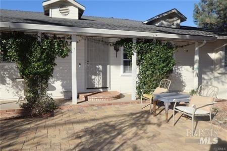 property entrance featuring a patio area