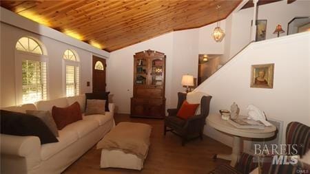 living room featuring wood ceiling, hardwood / wood-style floors, and lofted ceiling