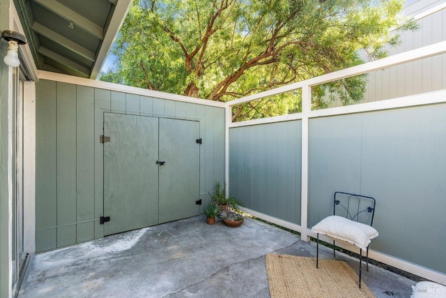 view of patio featuring a storage unit